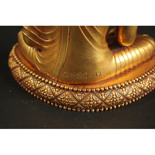 315 - A CHINESE GILT BRONZE SEATED BUDDHA, the reverse inscribed, 16cm high.