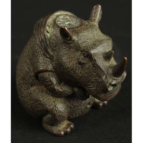 320 - A BRONZE OKIMONO OF A RHINOCEROS.