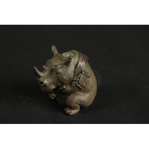 320 - A BRONZE OKIMONO OF A RHINOCEROS.