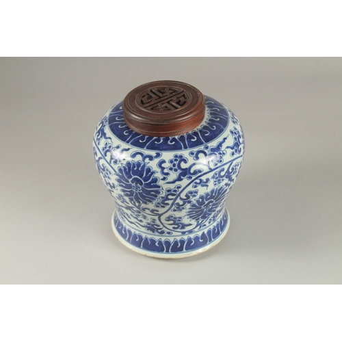 33 - A CHINESE BLUE AND WHITE PORCELAIN JAR AND HARDWOOD COVER, 23cm high.