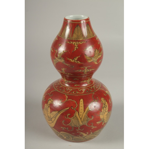 35 - A CHINESE RED GROUND PORCELAIN DOUBLE GOURD VASE, 23cm high.