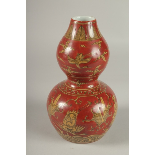 35 - A CHINESE RED GROUND PORCELAIN DOUBLE GOURD VASE, 23cm high.