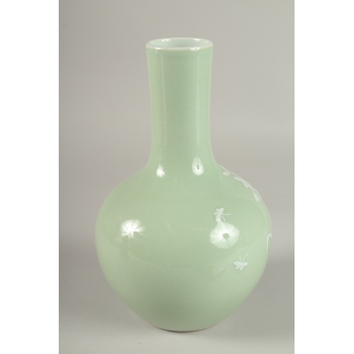 36 - A CHINESE CELADON GLAZE PORCELAIN FLORAL BOTTLE VASE, the base with character mark, 26cm high.