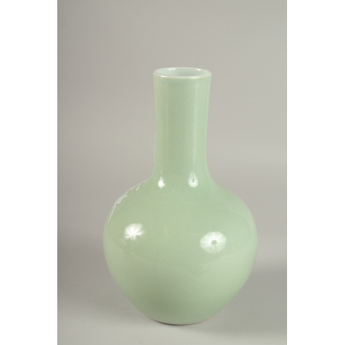 36 - A CHINESE CELADON GLAZE PORCELAIN FLORAL BOTTLE VASE, the base with character mark, 26cm high.