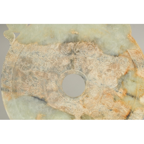 39 - A LARGE CHINESE JADE DISK, with incised characters, 33.5cm x 21cm.