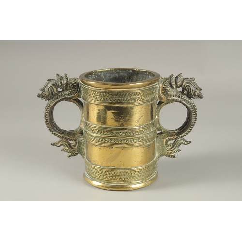 42 - AN UNUSAL GILT BRONZE TWIN HANDLE VESSEL, with strainer at the base, 15.5cm high.