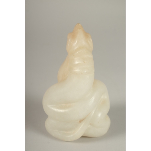 50 - A CARVED ALABASTER BUDDHISTIC FIGURE, with seated buddha and overarching dragon, 14cm high.