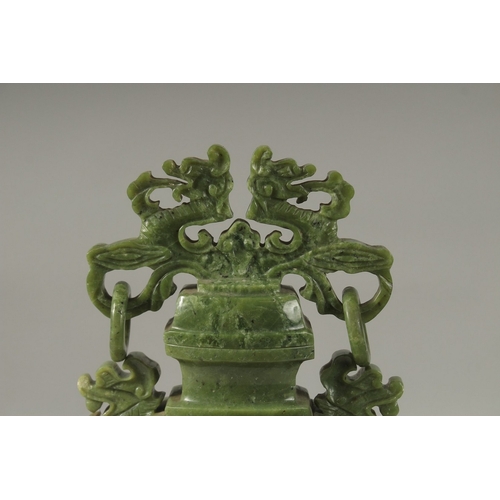 54 - A LARGE CHINESE CARVED GREEN HARDSTONE LIDDED VASE, with twin drop ring handles and carved with dog ... 