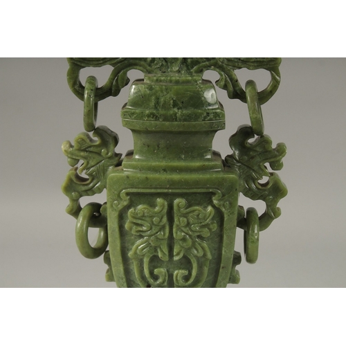 54 - A LARGE CHINESE CARVED GREEN HARDSTONE LIDDED VASE, with twin drop ring handles and carved with dog ... 