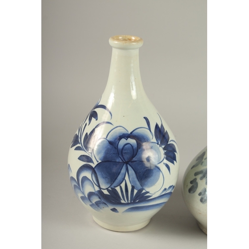 61 - TWO BLUE AND WHITE GLAZED PORCELAIN BOTTLES, 27cm high.