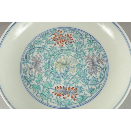 63 - A CHINESE POLYCHROME PORCELAIN FLORAL DISH, the base with six- character mark, 16cm diameter.