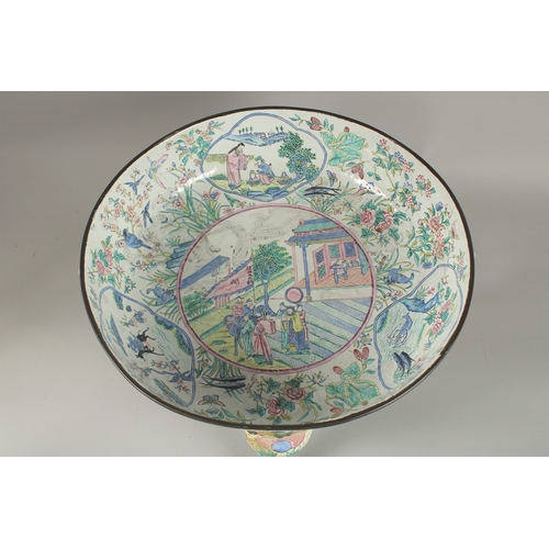 65 - A VERY LARGE CHINESE CANTON ENAMELLED BOWL, raised on curving tripod legs with shaped beast head han... 