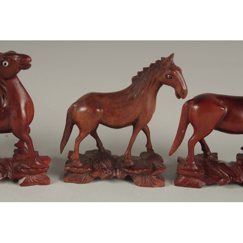 7 - A COLLECTION OF CARVED WOOD HORSES, with inlaid eyes, (6).