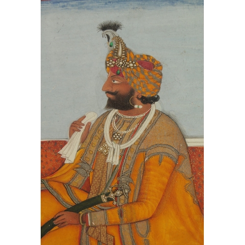 80 - AN INDIAN PAINTING ON PAPER A KNEELING ROYAL FIGURE, with fine floral border, framed and glazed, ima... 