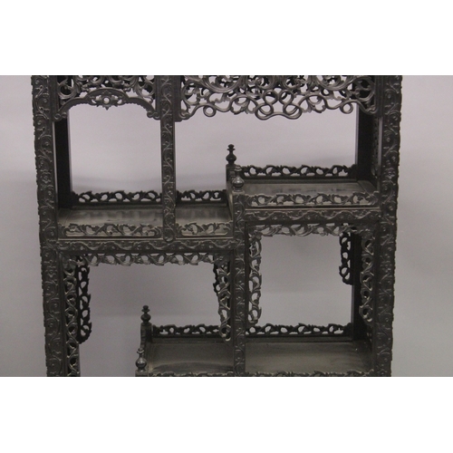 82 - A FINE CHINESE CARVED OPENWORK HARDWOOD DISPLAY CABINET, 154cm high, 8cm wide, 36cm deep.