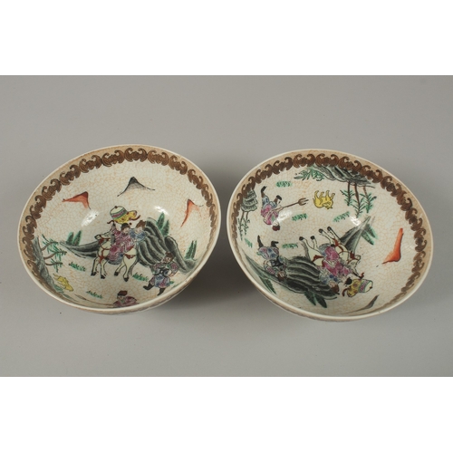 92 - A PAIR OF CHINESE PORCELAIN BOWLS, painted with figures on horseback, 15cm diameter.