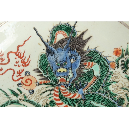 93 - A CHINESE FAMILLE VERTE PORCELAIN DRAGON PLATE, the base with six-character mark, 28cm diameter.