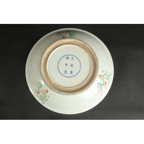 93 - A CHINESE FAMILLE VERTE PORCELAIN DRAGON PLATE, the base with six-character mark, 28cm diameter.