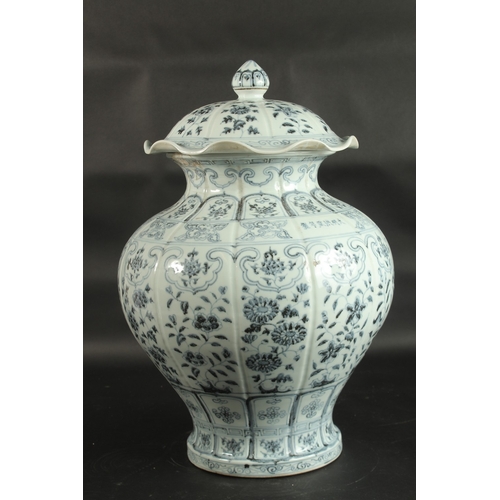 95 - A VERY LARGE CHINESE BLUE AND WHITE PORCELAIN FLORAL URN AND COVER, 55cm high.