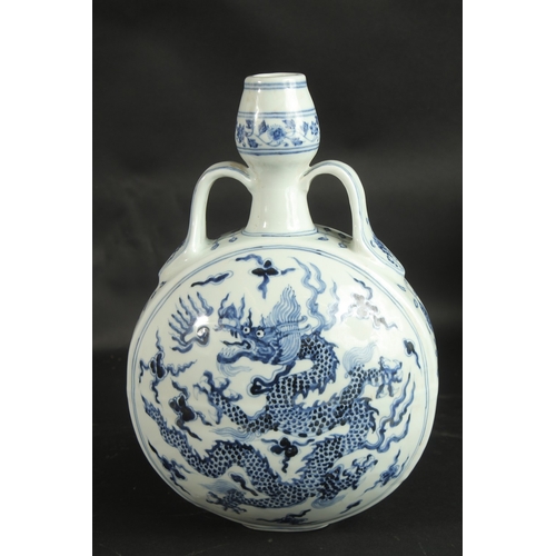 97 - A CHINESE BLUE AND WHITE PORCELAIN TWIN HANDLE DRAGON MOON FLASK, 32.5cm high.