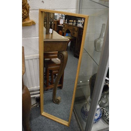 186 - A pair of oak framed narrow mirrors.