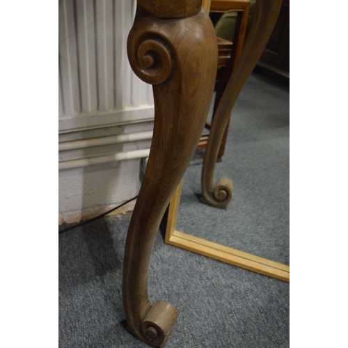 189 - A walnut console table with carved cabriole legs.