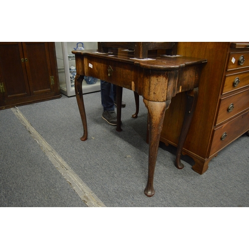 214 - An 18th century walnut single drawer side table (faults).