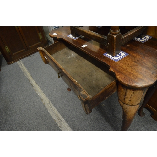 214 - An 18th century walnut single drawer side table (faults).