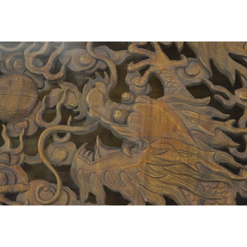 242 - A good large Chinese design hardwood square shaped coffee table, the carved central panel depicting ... 