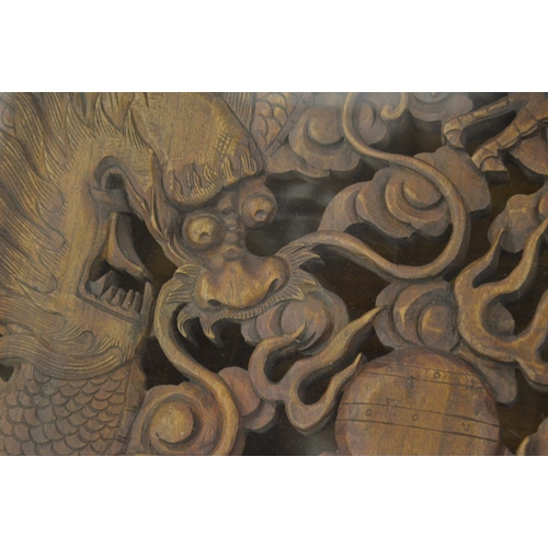 242 - A good large Chinese design hardwood square shaped coffee table, the carved central panel depicting ... 