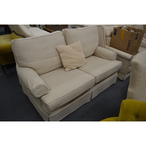 246 - A cream upholstered two seater settee.