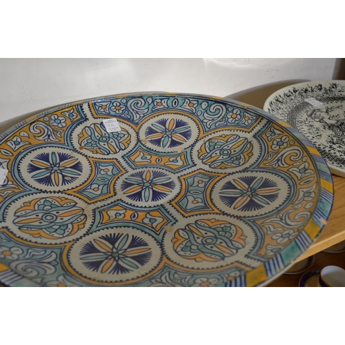 26 - Large colourful fruit bowl and three pottery chargers.