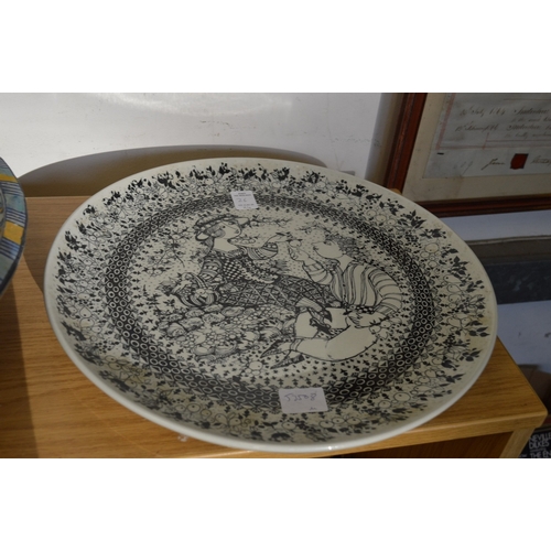 26 - Large colourful fruit bowl and three pottery chargers.