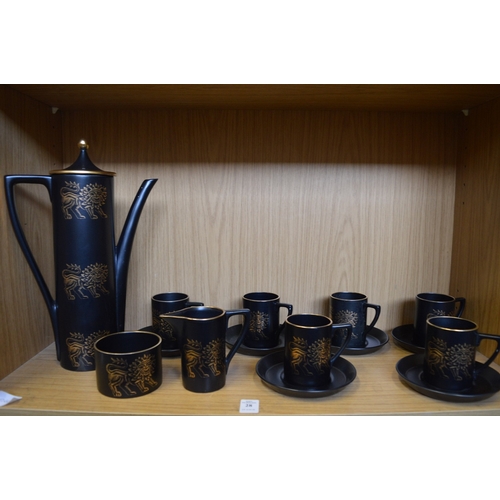 28 - A Portmeirion coffee service, black ground decorated with a gilt lion.