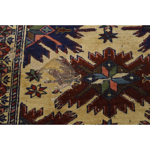 285 - A Persian design rug, cream ground with stylised decoration (moth damage) 162cm x 115cm.