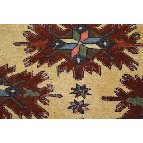 285 - A Persian design rug, cream ground with stylised decoration (moth damage) 162cm x 115cm.