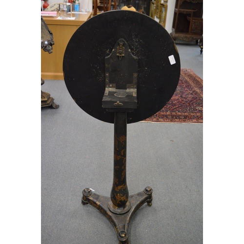 303 - A Victorian papier mache and gilt decorated tilt-top circular tripod table, the top painted with sce... 