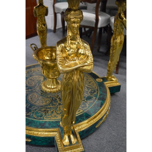 308 - An impressive faux malachite and ormolu circular two-tier centre table with figural supports.