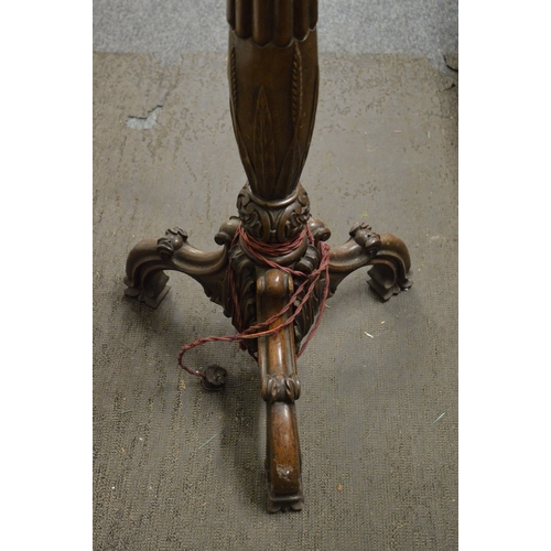 321 - A carved mahogany torchiere style floor standing lamp.