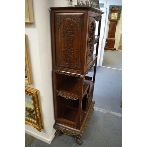 323 - A late 19th century carved hardwood display cabinet with two decoratively carved panel doors, a call... 