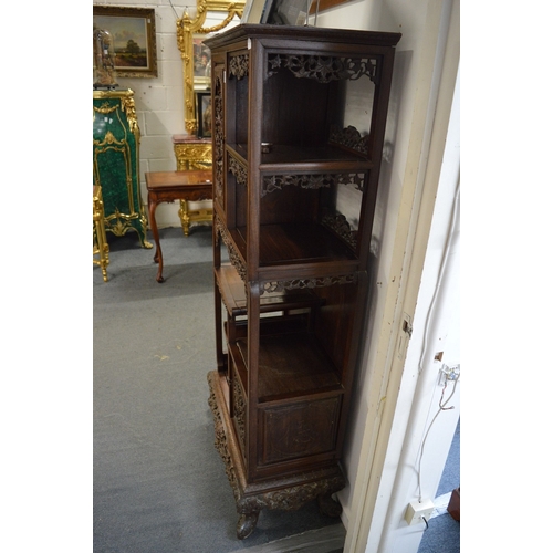 323 - A late 19th century carved hardwood display cabinet with two decoratively carved panel doors, a call... 