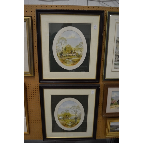 387 - Andrew Findlay, a pair of oval watercolour scenes of houses in a landscape, signed.