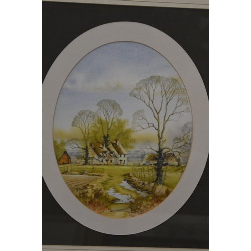 387 - Andrew Findlay, a pair of oval watercolour scenes of houses in a landscape, signed.