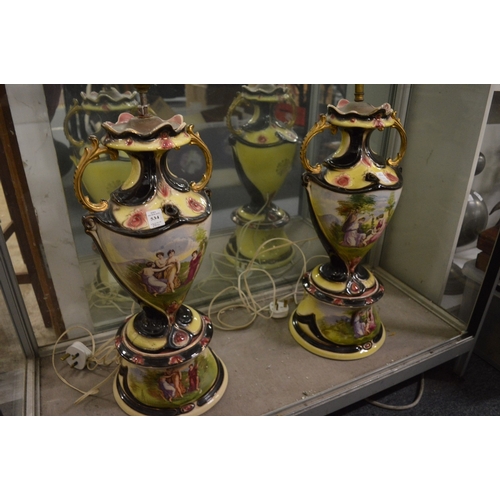 534 - A pair of decorative urn shaped pottery pedestal vases on circular bases.