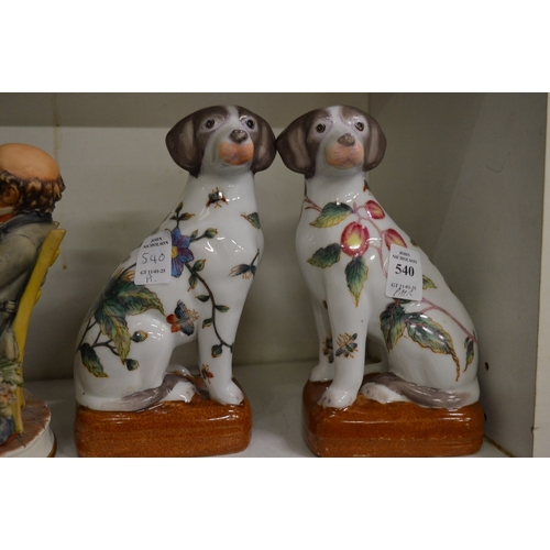 540 - A pair of reproduction Chinese porcelain models of seated dogs.