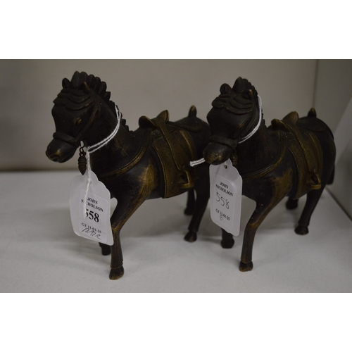 558 - A pair of cast bronze horses.