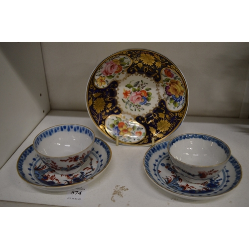 574 - A pair of 19th century cups and saucers and a floral decorated saucer.