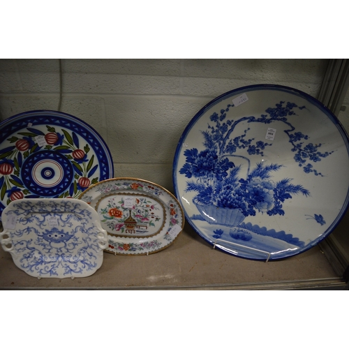 604 - A large Japanese blue and white charger (cracked) and three other dishes.