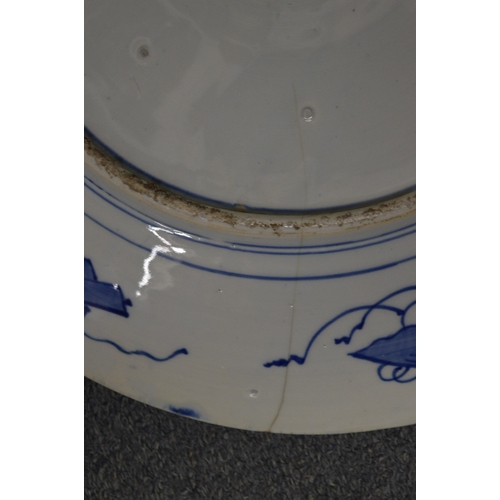 604 - A large Japanese blue and white charger (cracked) and three other dishes.