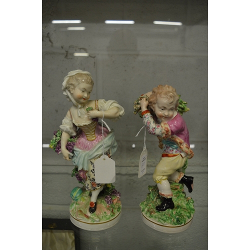 607 - A pair of 19th century porcelain figures of a young boy and girl.